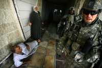 Soldados estadunidenses irrumpen en una casa en Bagdad, durante la búsqueda de supuestos rebeldes