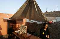 Una mujer vela el cadáver de su tío, en la localidad de Pisco